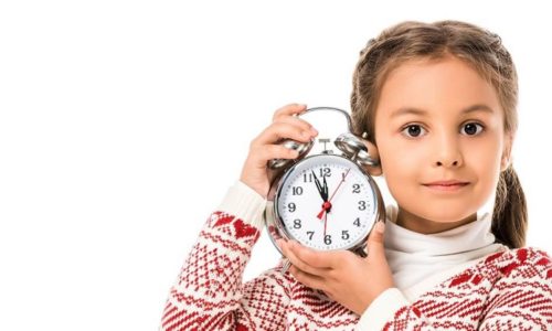 Foster child with clock, waiting on new foster parents.